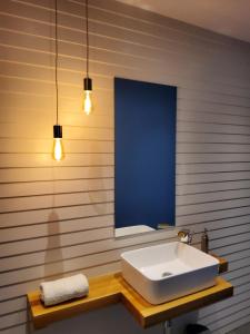 a bathroom with a white sink and a mirror at La Casa del Río in Zamora