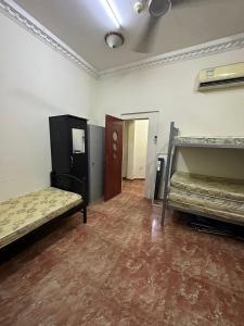 an empty room with two beds and a hallway at Bed Space for Female single and bunk bed Al Sayed Builidng - Sharaf DG Exit 4 Flat 301 in Dubai