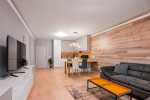 a living room with a couch and a table at Urban Elegance at Its Finest Stylish 1-BD Flat in Sofia