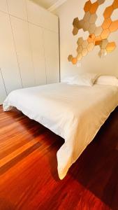 a bedroom with a white bed with a wooden floor at VIGO CENTER SEREO OLD TOWN in Vigo