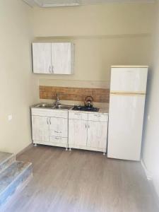 uma cozinha com 2 lavatórios e um frigorífico em Mtatsminda Apartment Best View em Tbilisi