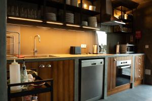 a kitchen with a sink and a dishwasher at Monte das Mogueiras in Avis
