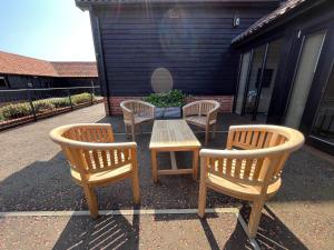 a group of chairs and a table and a table and chairs at White House Lodges in Heveningham