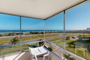 a view of the ocean from the balcony of a house at Oceana Suites en Esturion, frente a playa Brava in Punta del Este