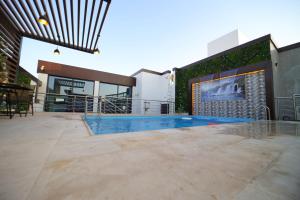 a swimming pool on the roof of a building at PRIMOTEL Elite As Salamah - Serviced Apartments in Jeddah