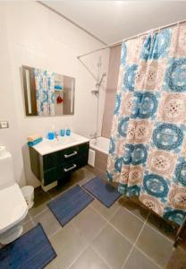 a bathroom with a sink and a toilet and a shower at Appartement vue sur mer avec piscines in Mohammedia