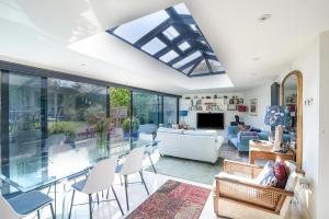 a living room with a glass table and chairs at Stable Cottage in Bridport