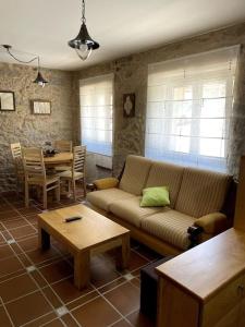 a living room with a couch and a table at Casa Rochiña in Pobra do Caramiñal