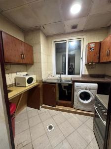 a kitchen with a sink and a washing machine at Bed Space for Female single and bunk bed Al Sayed Builidng - Sharaf DG Exit 4 Flat 301 in Dubai