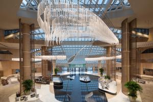 a large chandelier in a building with a pool at Radisson Collection Lingang Shanghai in Shanghai