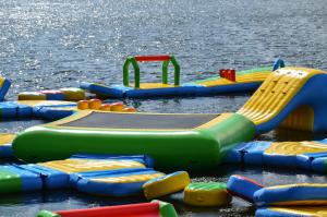 a group of inflatable play equipment in the water at Hotel resort Sedula in Skogalis