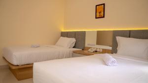 Ένα ή περισσότερα κρεβάτια σε δωμάτιο στο Hotel Luansa Klui