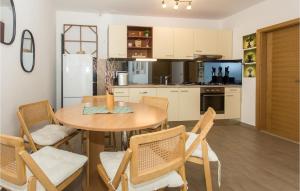 a kitchen with a table and chairs in a room at Nice Home In Trilj With House A Panoramic View in Trilj