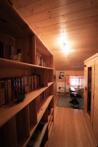 a room with bookshelves and a room with a chair at Ferienwohnung Zedlacher in Kartitsch