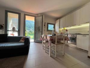 Introbio[Introbio-Lecco] La casa di Lucy vista montagna的带沙发和桌子的客厅和厨房