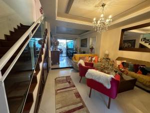 a living room with a chandelier and a staircase at Hotel Pousada Irmaos Freyhardt in Rio de Janeiro