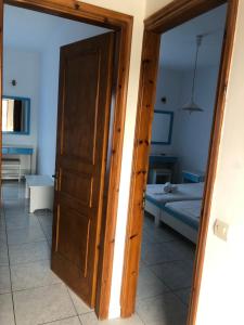 an open door to a bedroom with a bed at Diomare Villas in Kypseli