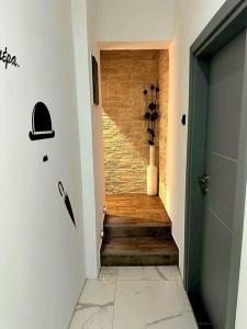 a hallway with a staircase with a door and a brick wall at Sevi House Suite in Thessaloniki
