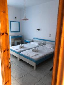 a bedroom with two beds with towels on them at Diomare Villas in Kypseli