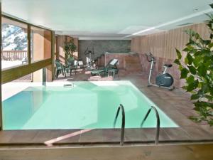 a swimming pool in a house with a patio at Appartement Valloire, 3 pièces, 6 personnes - FR-1-263-271 in Valloire
