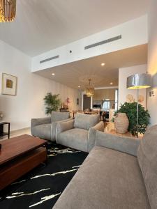 a large living room with couches and a table at ROYAL APARTMENTS DUBAI in Dubai
