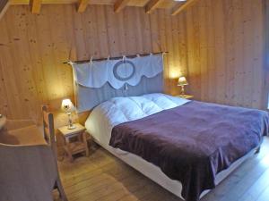 a bedroom with a large bed in a wooden wall at Chalet Samoëns, 8 pièces, 14 personnes - FR-1-629-1 in Samoëns