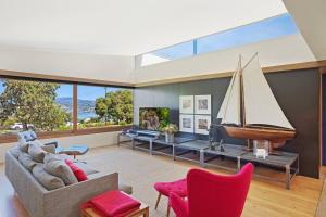 a living room with a sail boat on the wall at 24 Hill Street- Unique 2 bedroom pet friendly home in Merimbula