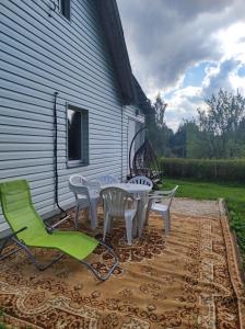 a patio with a table and chairs next to a building at Bluci seksti in Seksti