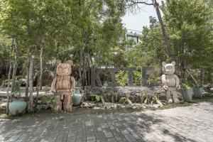 two statues of bears sitting next to a bench at Unlock Your Dream Getaway-Escape in Tulum