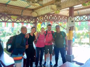 a group of people posing for a picture at Jungle treking & Jungle Tour booking with us in Bukit Lawang