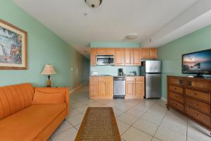 a living room with a couch and a kitchen at Nw Condo Across Beach Pool & Parking in North Wildwood