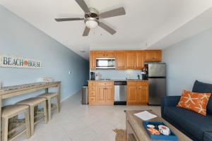 a living room with a couch and a kitchen at Nw Condo W Private Balcony & Pool in North Wildwood