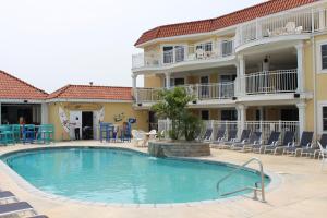 a large swimming pool in front of a building at Nw Vacation Rental Condo W Pool & Ocean Views in North Wildwood