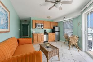 a living room with a couch and a table at Partial Ocean View Condo W Pool & Parking in North Wildwood