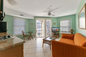 a living room with a couch and a table at Partial Ocean View Condo W Pool & Parking in North Wildwood