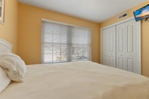 a bedroom with a bed and a window at Partial Ocean View Condo W Pool & Parking in North Wildwood