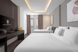 Postelja oz. postelje v sobi nastanitve Mercy Emerald Hotel