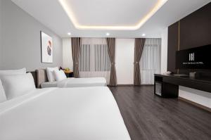 Postelja oz. postelje v sobi nastanitve Mercy Emerald Hotel