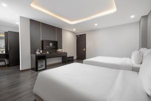 Postelja oz. postelje v sobi nastanitve Mercy Emerald Hotel