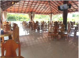 a restaurant with tables and chairs and people sitting at tables at HOTEL Y RESTAURANTE RANCHO DE SEBAS in Nicoya