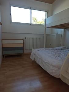 a bedroom with a bed and a large window at Appart'cosy - 7 personnes in Saint-ouen-dʼAunis