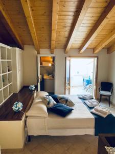a large bed in a room with a wooden ceiling at Sweet Dream House in Carloforte