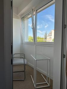 a room with a table and a chair and a window at Appartement Lena in Linz