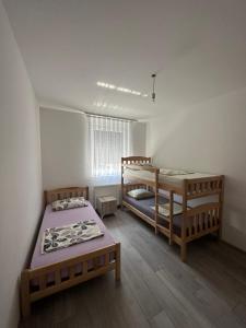 1 dormitorio con 2 literas y ventana en Modern Apartment, en Ferizaj