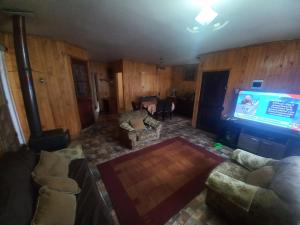 a living room with couches and a flat screen tv at Doña Nancy in Temuco