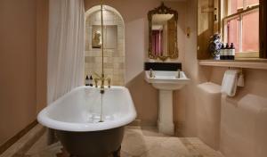 a bathroom with a bath tub and a sink at The Rookery in London +37 photos