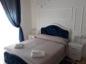 Il Castello Di Venere في روتا ديماغنا: غرفة نوم عليها سرير وفوط