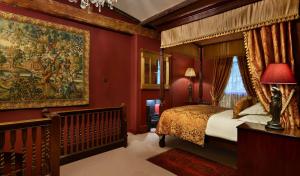 a bedroom with a canopy bed and a large tapestry at The Rookery in London