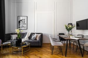 - un salon avec un canapé et une table dans l'établissement Cracovian Apartment by Loft Affair, à Cracovie