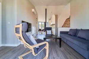 a living room with a chair and a couch at Apartamentos Carballal in Palas de Rei